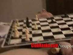 Chess match on naked body, pussy holds pieces.
