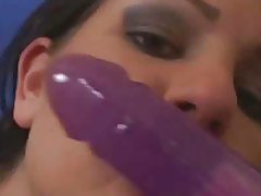 Sucking on a dildo and fucking her pussy with it