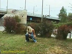 Blonde girl takes a piss right on the ground