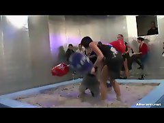 Girls jousting and wrestling in the mud
